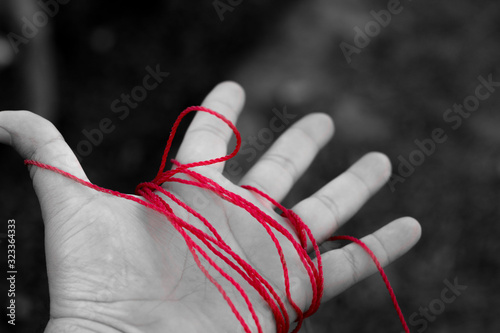 Hand with red color wire edited nicely with adobe lightroom and photoshop