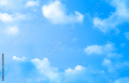    blue sky against white floating clouds background