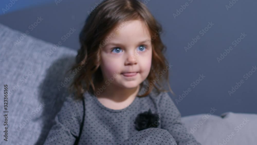 little girl in a gray dress is photographed in the Studio little girl in a gray dress is photographed in the Studio