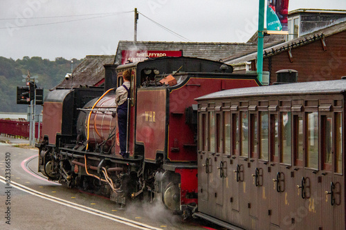 Welsh Highland Railway Engine and car traveling in Porthmadog