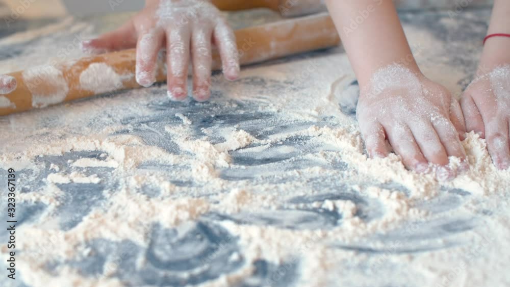 Four children's hands playing with flour Four children's hands playing with flour