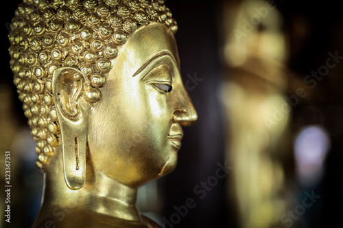 Selective focus close-up shots of Buddha statues that are used as amulets of Buddhism  © Ping198