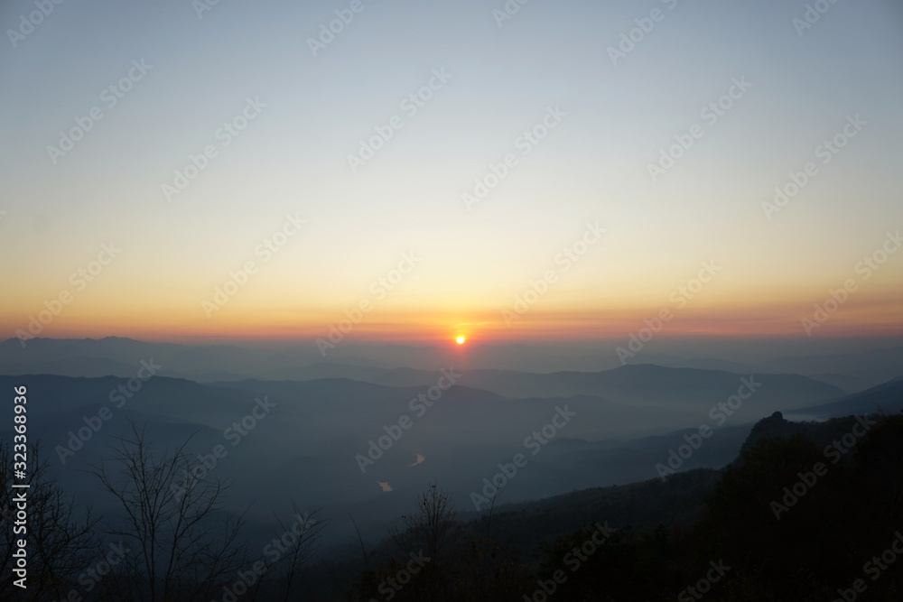The view of the sunrise and the beautiful sky in the morning. View from the top of the mountain in Sri Nan National Park, Thailand. Image contain certain grain or noise and soft focus.
