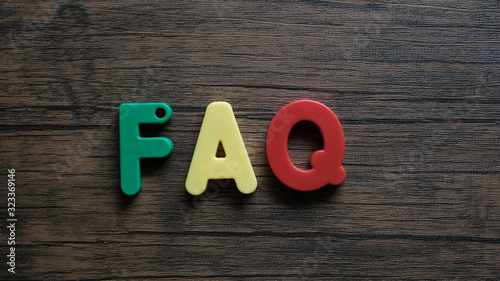 Wallpaper Mural Word 'FAQ' from wooden letters on dark wooden background Torontodigital.ca