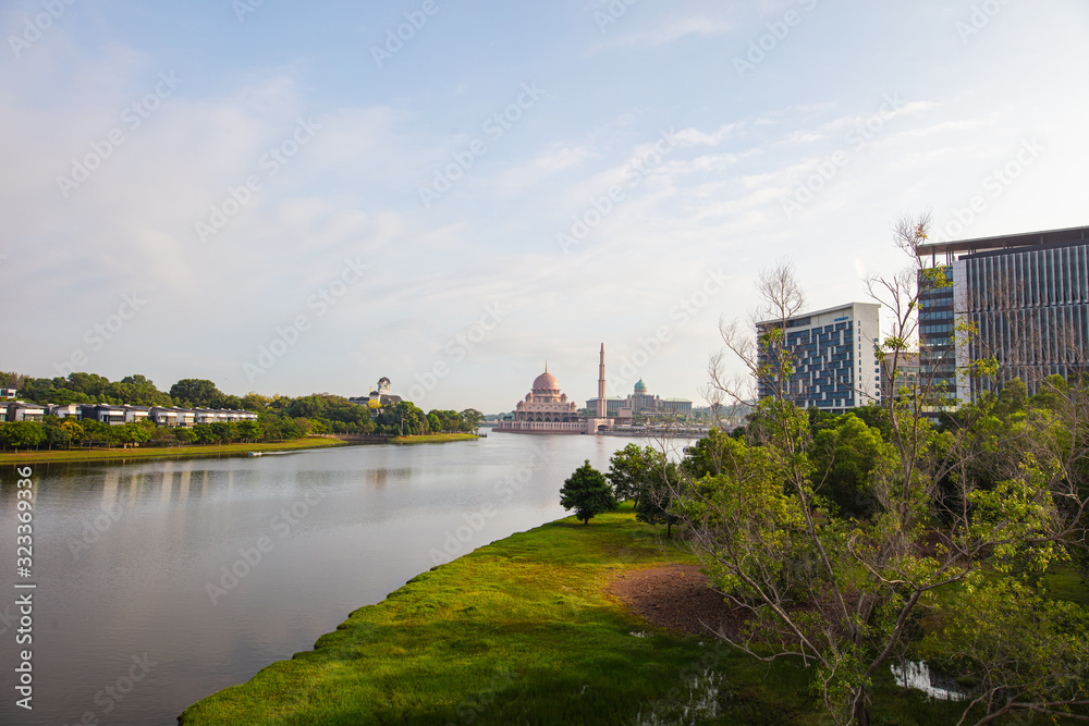 The skyline or cityscape of the Malaysian government city Putrajaya. in the background the Putrajaya mosque and the Putra lake. In the foreground one of many parks in Putrajaya, Malaysia. 
