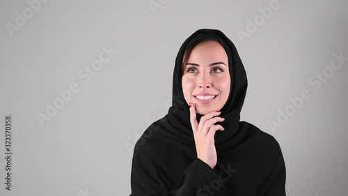 Arabian girl brainstorming, Idea Concept, Arabian girl pondering a solution, doubting question. photo