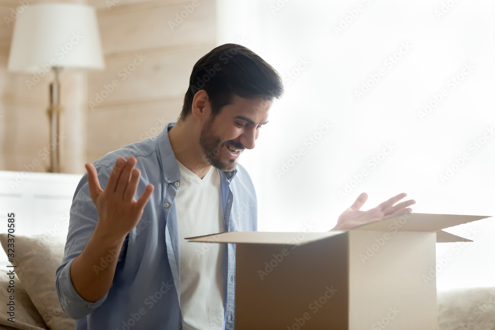 Happy male customer unpack online shopping order Happy male customer unpack online shopping order