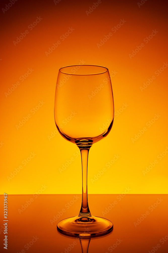 Wine glass on a yellow-orange background with a gradient