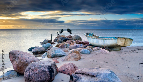 Abandoned fishing boat after storm near a village of fishermen, Baltic Sea