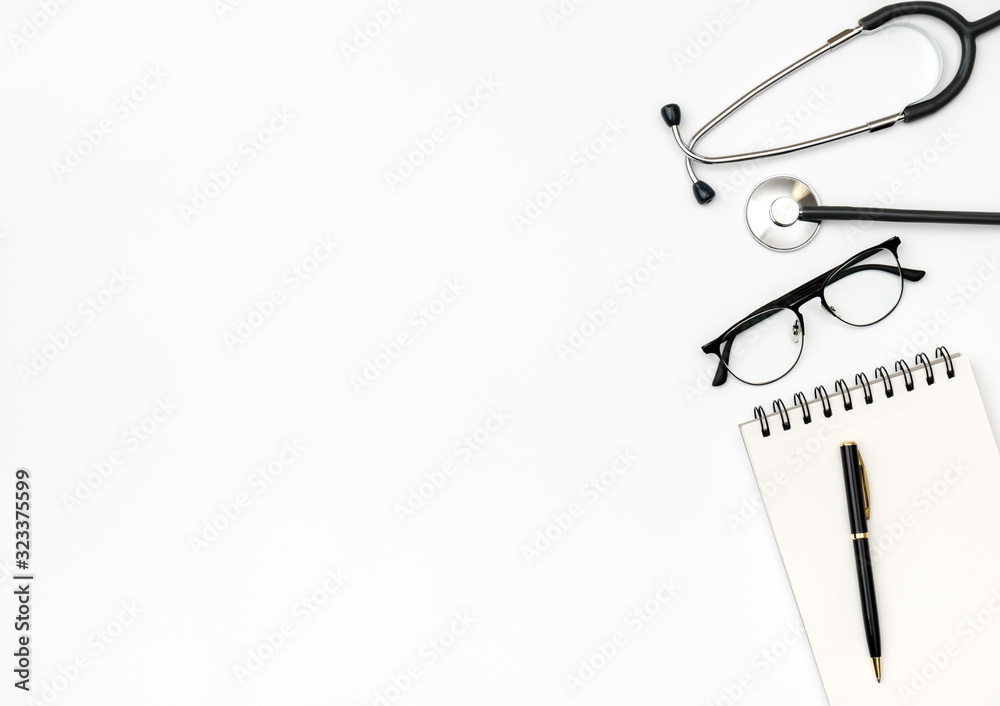 Workplace of doctor with notebook and stethoscope Workplace of doctor with notebook and stethoscope