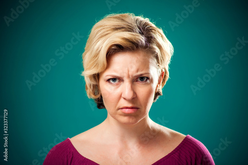 Sad woman with short blond hair. People, lifestyle and emotions concept