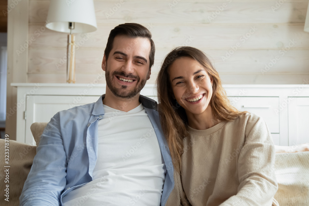 Smiling young couple talk on video call ta home Smiling young couple talk on video call ta home