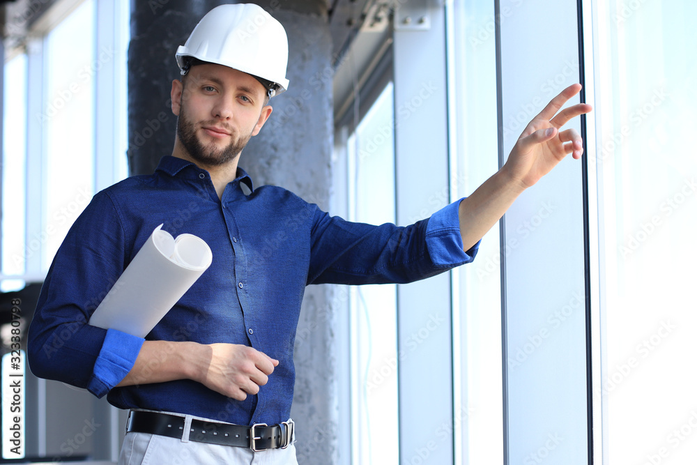 Shot of male architect wearing hardhat and inspecting new building. Shot of male architect wearing hardhat and inspecting new building.