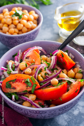 Salad with tomatoes, chickpeas and red onions, selective focus