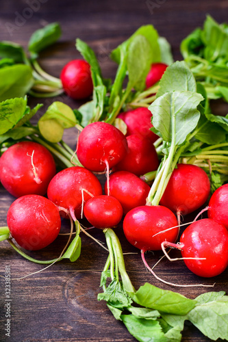 Fresh radish radishes on a wooden background, seasonal vegetables healthy food. vitamin salad recipe