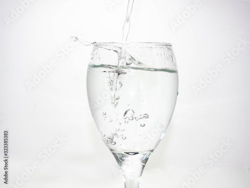 Pour water into the glass until small bubbles of various shapes are formed. White background