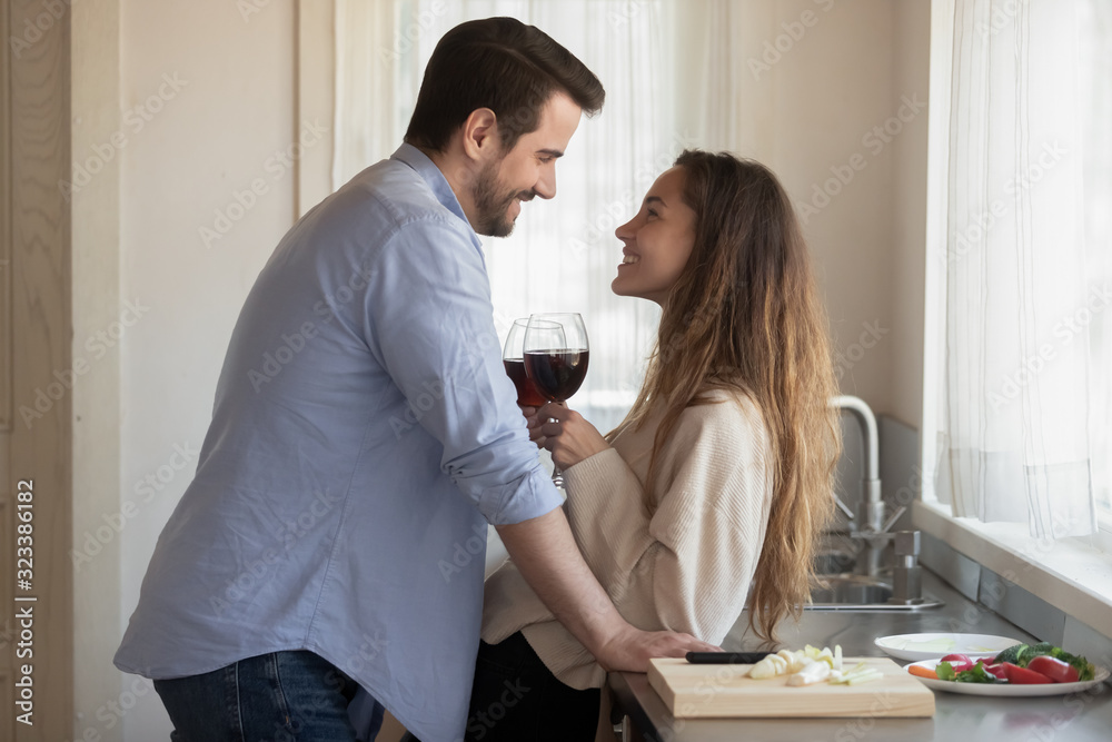 Loving newlyweds enjoy romantic date in kitchen Loving newlyweds enjoy romantic date in kitchen