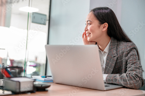 Asian young woman is woking in office