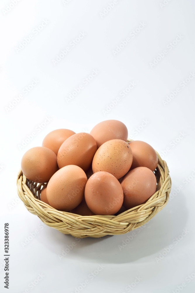 Eggs are laid in a wicker basket. On a white background Eggs are laid in a wicker basket. On a white background