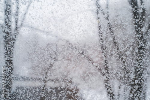 Snowfall. The texture of a snowy window. Snowflakes adhered to the glass.