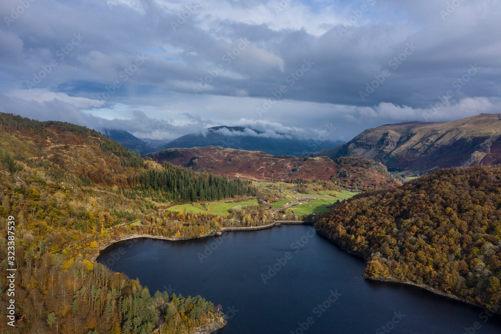 Stunning aerial drone landscape image of glorious vibrant Autumn Fall sun over Thirlmere in Lake District