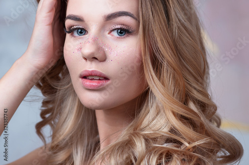 Sequins in makeup, a fashionable youth trend. Beautiful young girl