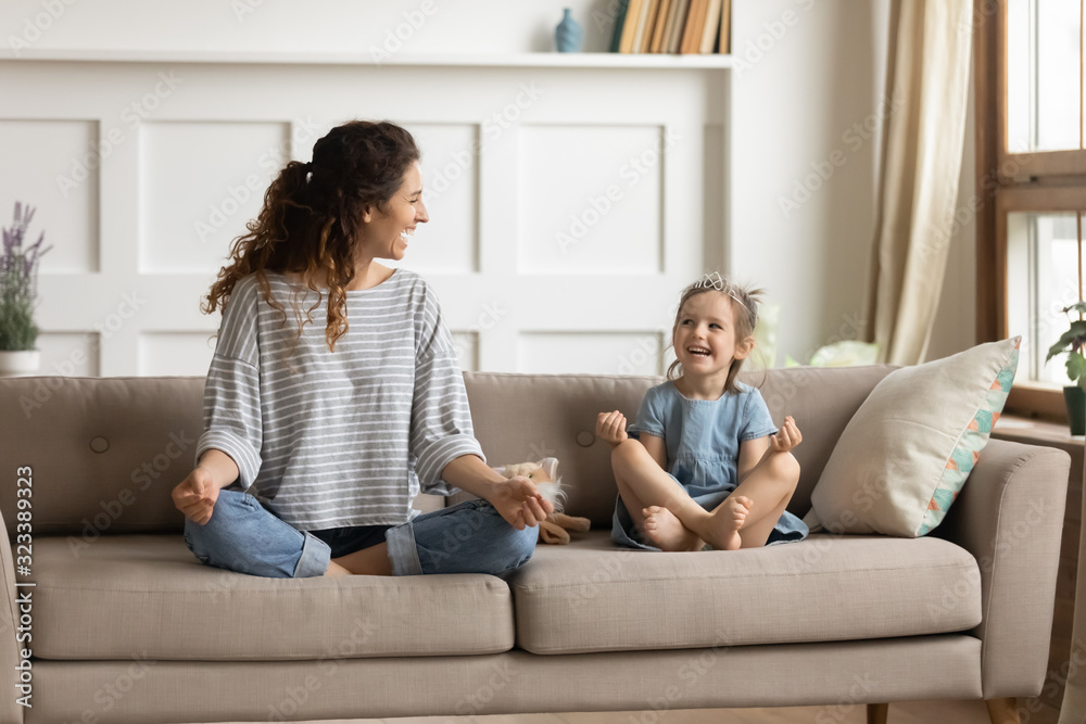 Fototapeta premium Happy mommy practicing yoga exercised with small child.