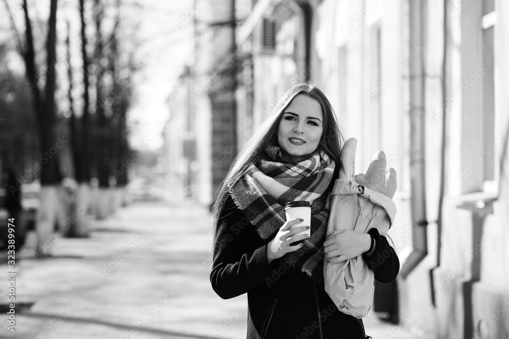 Fototapeta premium Black and white photo of a young girl on a walk