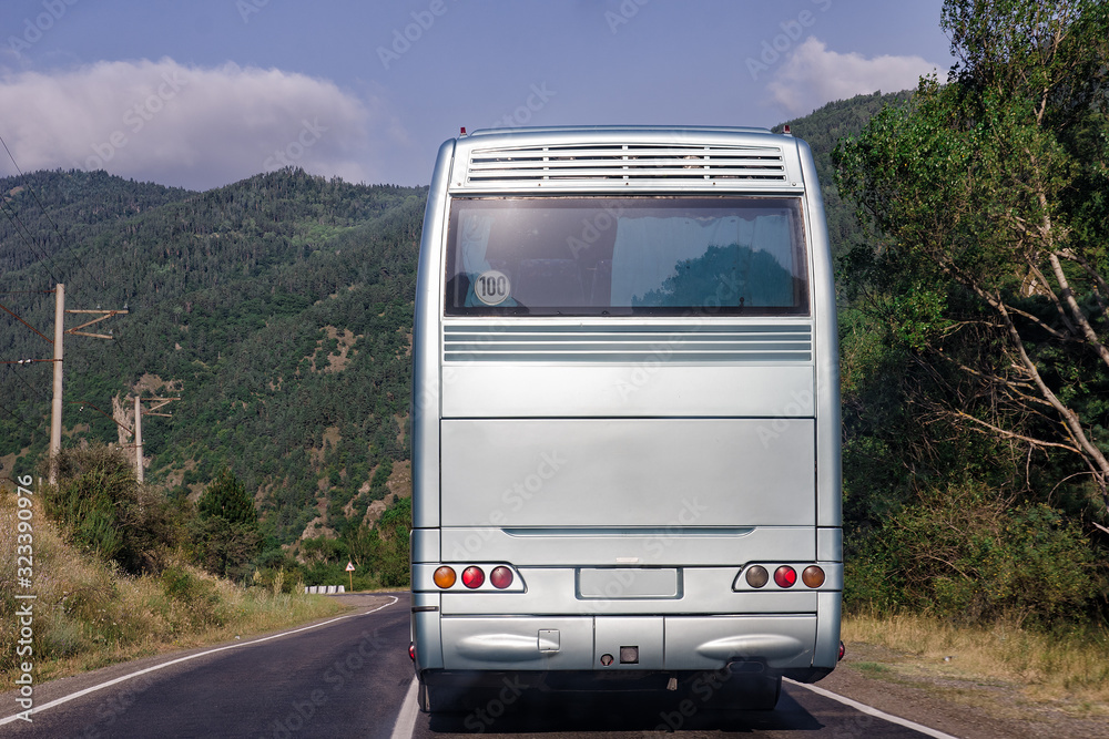 Rear side of bus. Behind white bus on nature background. Place for text. Close up