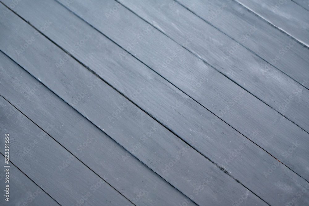Black wooden backdrop with diagonal lines. Gray Board background with copy space