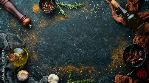 Black stone cooking banner. Spices and herbs. Top view.
