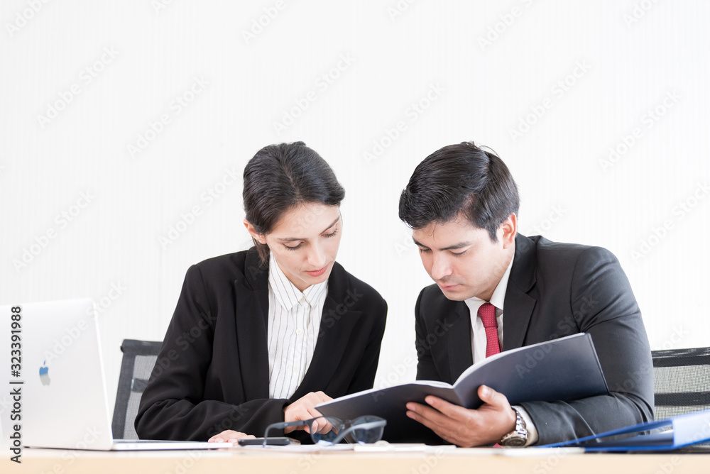 A manager and secretary working together in the office. A manager and secretary working together in the office.