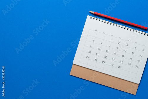 close up of calendar on the blue table, planning for business meeting or travel planning concept