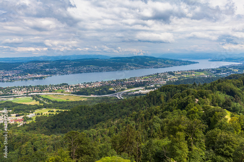 Stunning aerial panorama view of Zurich cityscape skyline and Zurich lake from top of Uetliberg mountain on a cloudy summer day with beautifil cloudscape in sky, Switzerland © Peter Stein