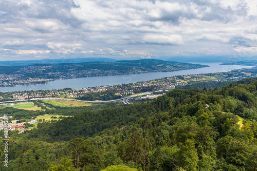 Fototapeta Naklejka Na Ścianę i Meble -  Stunning aerial panorama view of Zurich cityscape skyline and Zurich lake from top of Uetliberg mountain on a cloudy summer day with beautifil cloudscape in sky, Switzerland