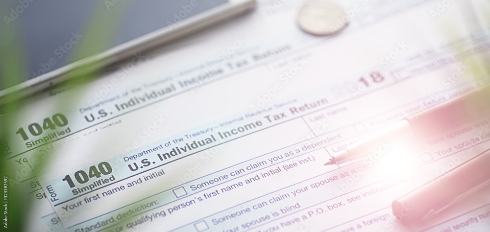 Fototapeta premium Annual tax reporting. Tax form on the table. Financial statements for signature.