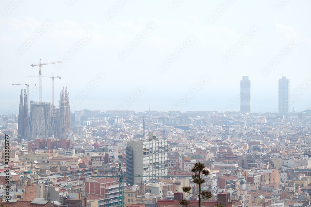 View of Barcelona from Parc Guëll with the Sagrada Familia, Twin towers and the Mediterranean Sea