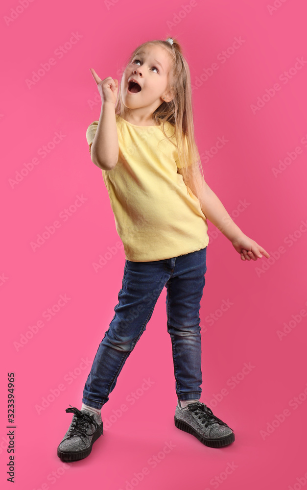 Full length portrait of emotional little girl on pink background Full length portrait of emotional little girl on pink background