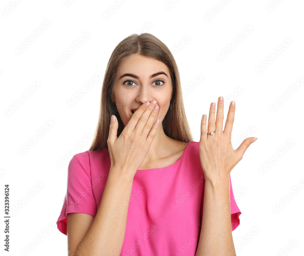 Emotional young woman wearing beautiful engagement ring on white background Emotional young woman wearing beautiful engagement ring on white background