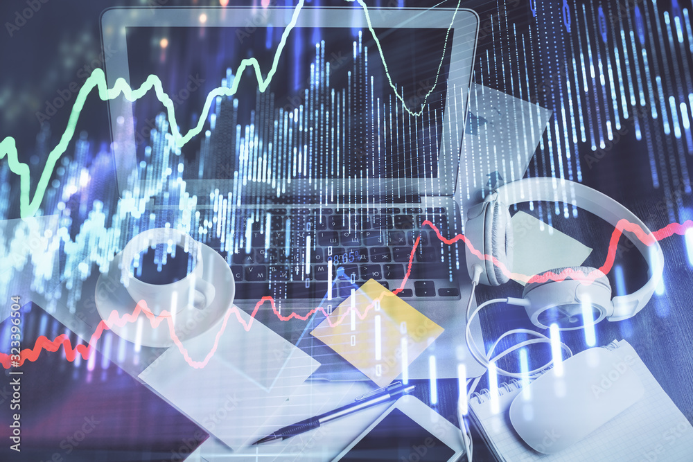 Financial market graph hologram and personal computer on background. Multi exposure. Concept of forex. Financial market graph hologram and personal computer on background. Multi exposure. Concept of forex.