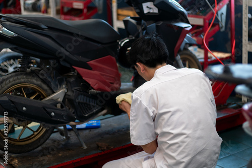 Mechanic who is fixing motorcycles