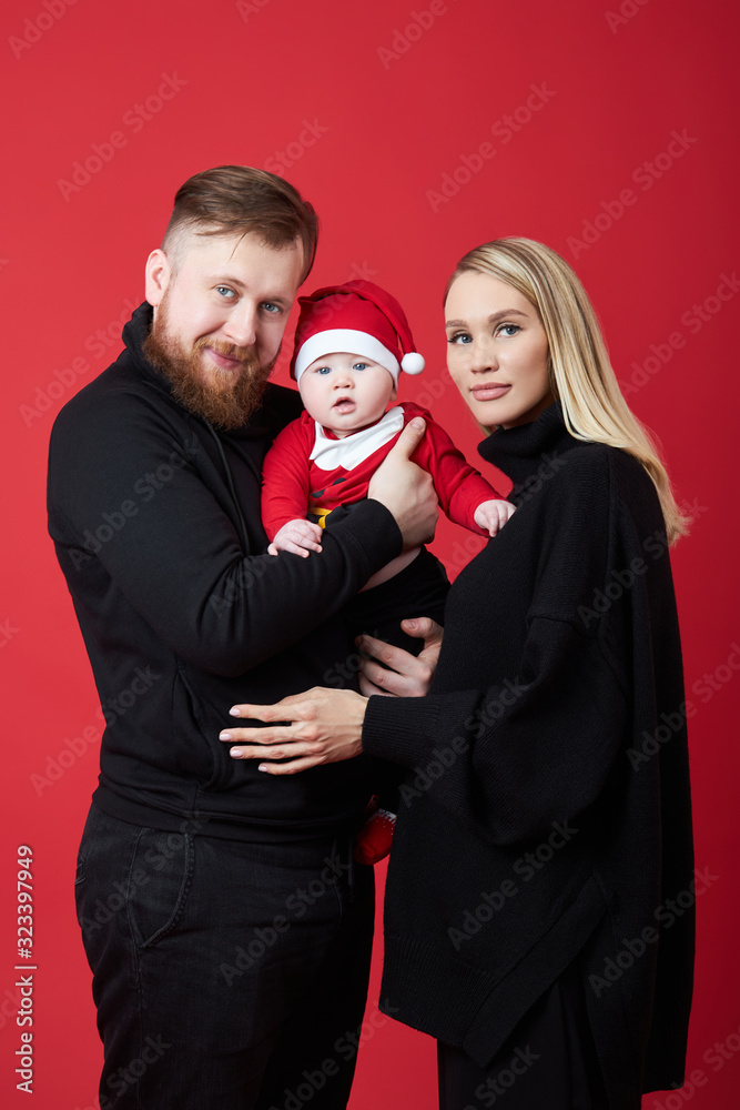 Man and a woman hold a baby in their arms. Portrait of a married couple after the birth of a child. Young family Man and a woman hold a baby in their arms. Portrait of a married couple after the birth of a child. Young family