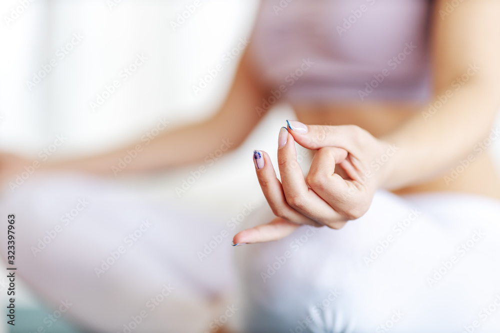 Close up of calm woman sitting and meditating. Selective focus on hand. Close up of calm woman sitting and meditating. Selective focus on hand.