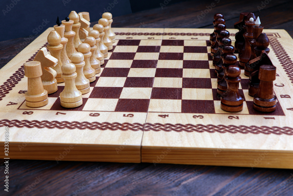 Chess game on a wooden background. Chess match.