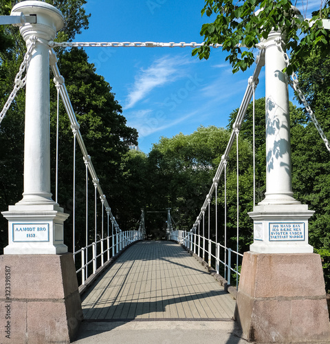 Pedestrian bridges over the Akers River in Oslo, Norway. Built in 1851 over the Drammen River and moved to its Oslo in 1962 photo