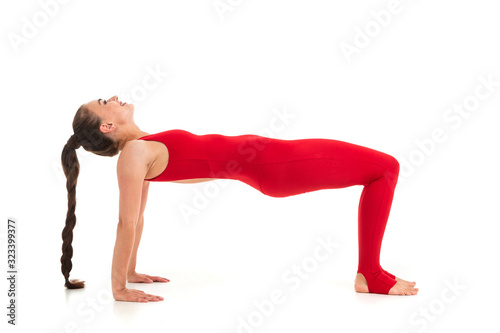 Healthy woman in t-shirt and leggins doing gymnastics and meditating isolated on white background