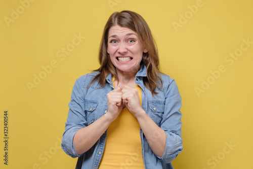 Awkward caucasian woman feeling embarrassed, confused nervous before exam