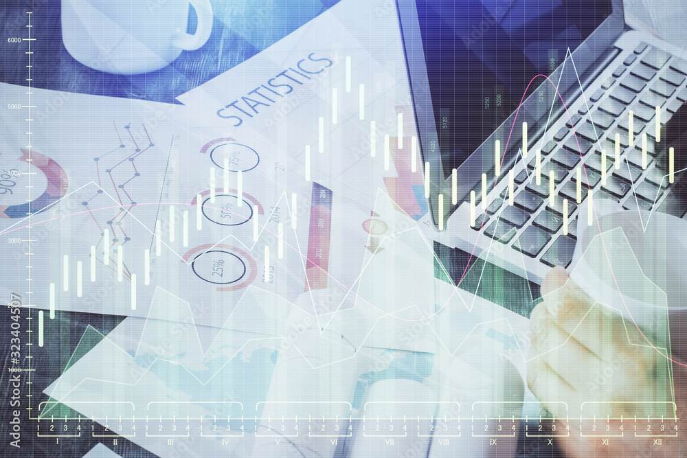 Double exposure of stock graph with businessman typing on computer in office on background. Concept of hard work. Double exposure of stock graph with businessman typing on computer in office on background. Concept of hard work.