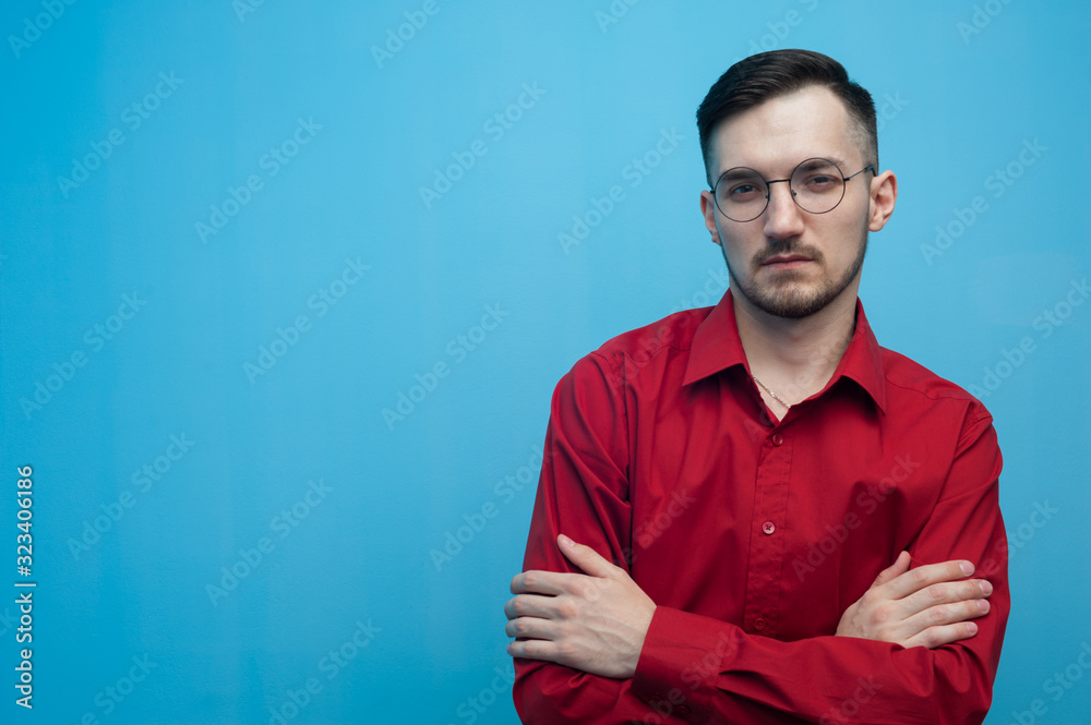 Fototapeta premium Young man in glasses and a burgundy shirt