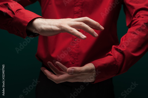 Man in a red shirt carefully hold invisible object